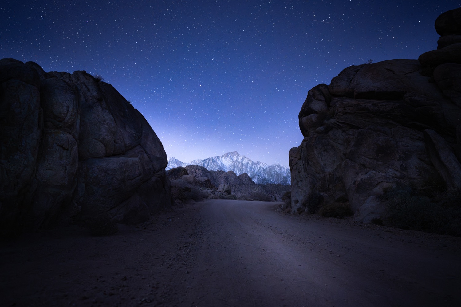 The Milky Way over a dark landscape